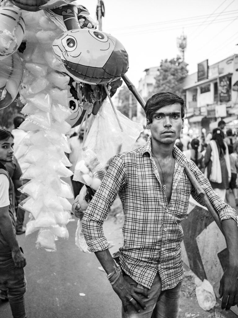 black and white photo of a man with ballons